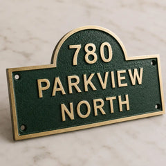 Custom brass address plaque with arched top and personalized house number
