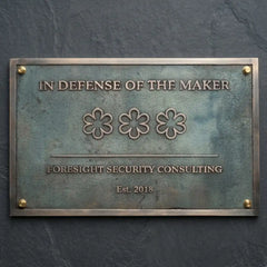 Outdoor bronze address plaque mounted on a brick wall