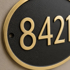 Custom engraved oval brass door sign with house number