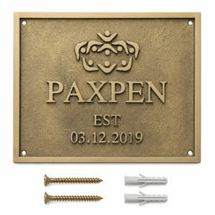 Custom brass address plaque with two mounting screws and two wall anchors arranged for easy wall installation.