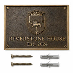 Custom brass address plaque with two mounting screws and two wall anchors arranged for easy wall installation.