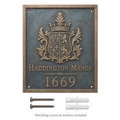Custom bronze house number plaque displayed with mounting hardware, including two screws and two wall plugs.
