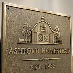 Custom brass plaque with engraved address, names, and decorative lettering