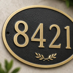 Handcrafted oval brass house number sign for home entrance