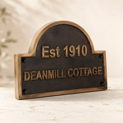 Bronze address plaque with custom name and number for outdoor home entrance