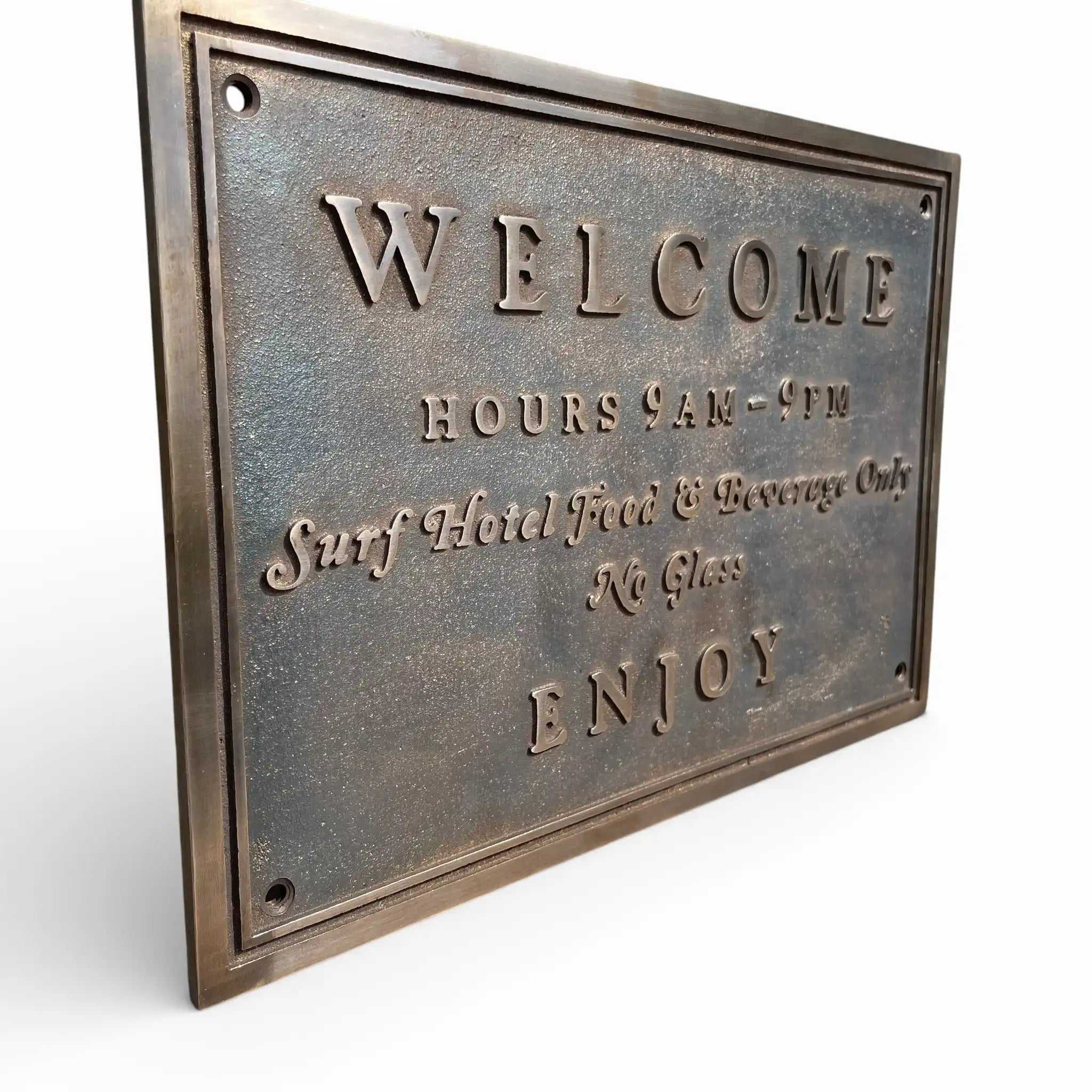 Bronze plaques welcome sign with text on a white background