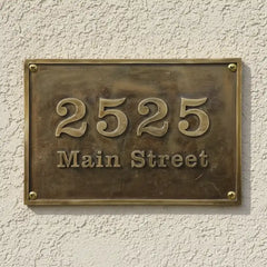 Antique Brass House Number Plate – Personalized Door Sign on a textured wall.