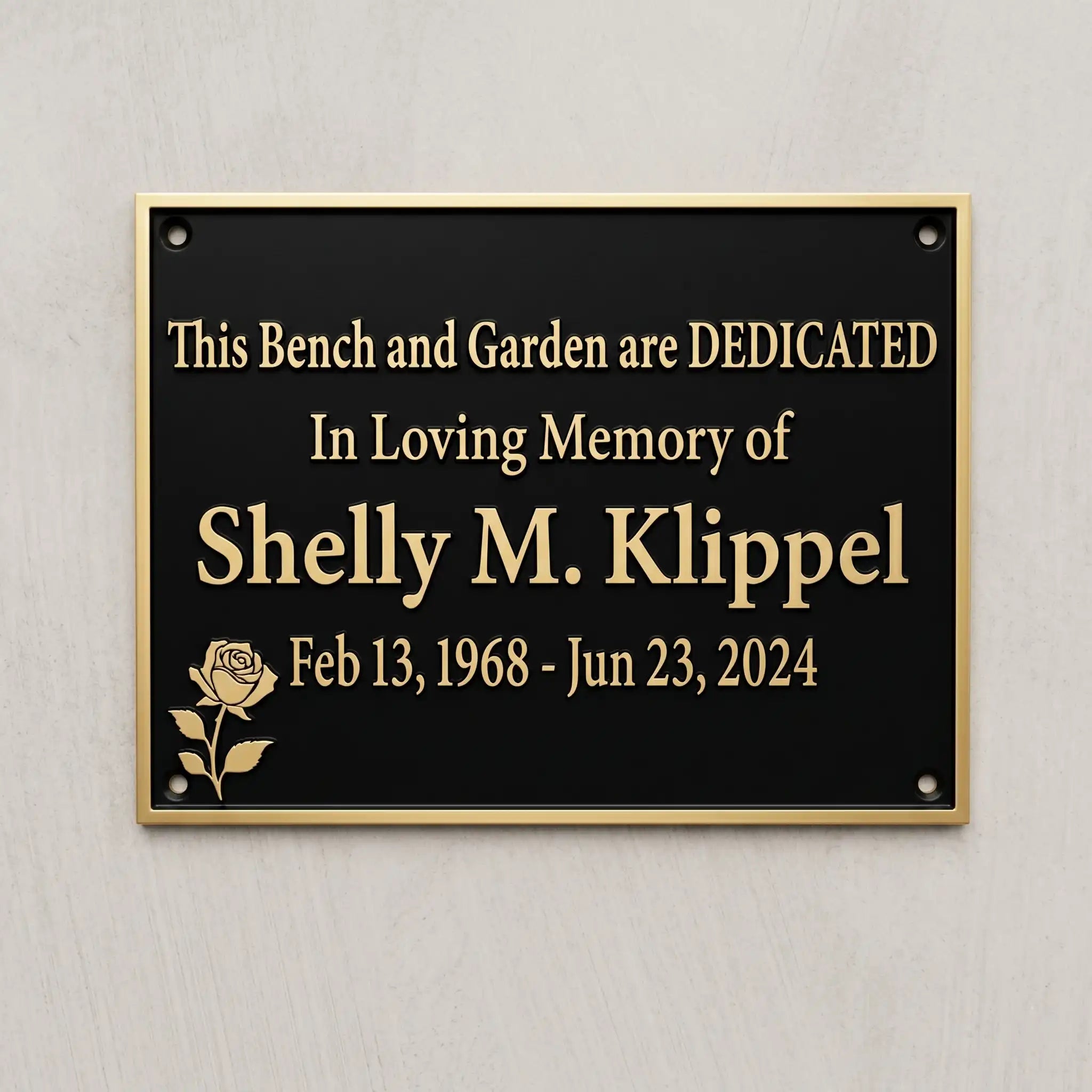 Memorial plaque dedicated to Shelly M. Klipel on a gray wall.
