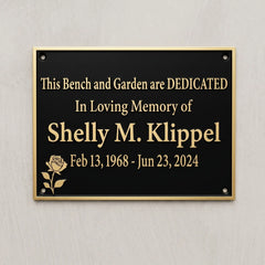 Memorial plaque dedicated to Shelly M. Klipel on a gray wall.