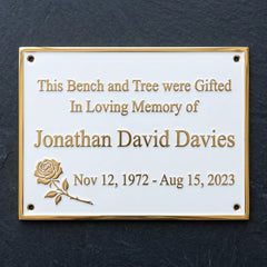 Memorial plaque with engraved text on a dark background