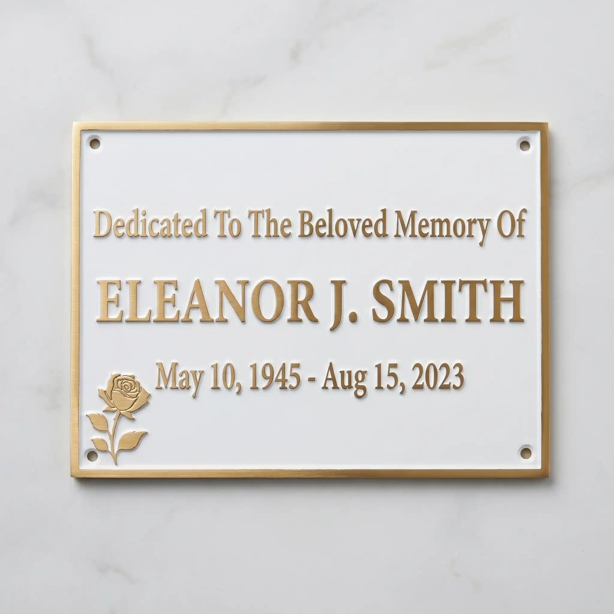 Memorial plaque dedicated to Eleanor J. Smith with a rose design on a white background