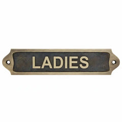 Brass door sign with 'LADIES' text antique on a white background