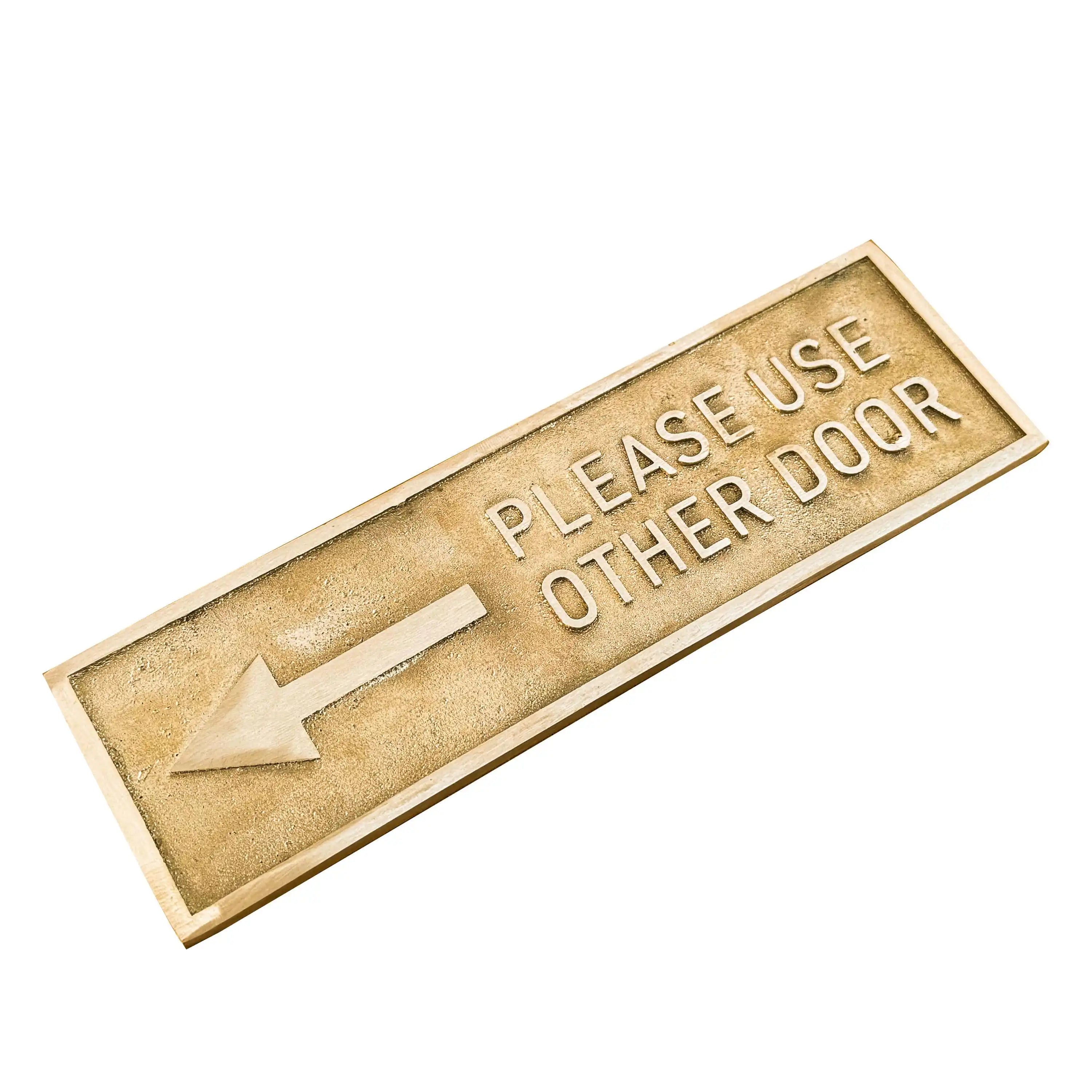 Brass Door sign with text 'Please use other door' and an arrow on a white background