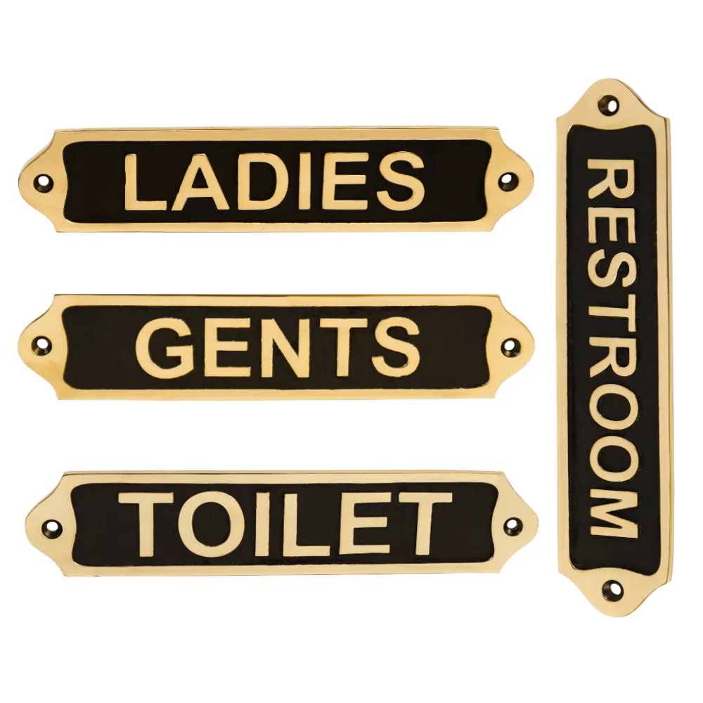 A set of four brass plaques with black text, indicating the locations for ladies, gents, and toilet in a home or commercial setting.
