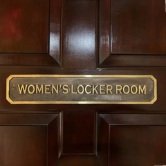 Wooden door with a gold 'WOMEN'S LOCKER ROOM' Brass Door Sign