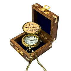Gold pocket watch in a wooden box with engraved text on a white background