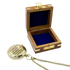 Wooden box with a gold lid and a gold necklace with a pendant on a white background
