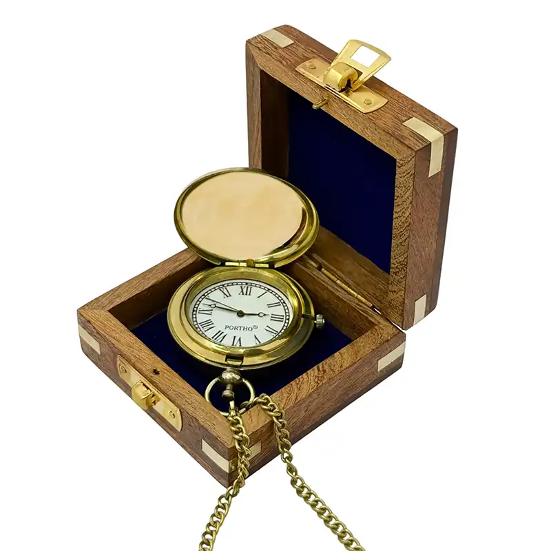 Gold pocket watch in a wooden box on a white background