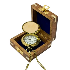 Gold pocket watch in a wooden box on a white background