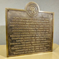 Cast Bronze plaque with engraved custom text about Four Pines Ranch on a neutral background