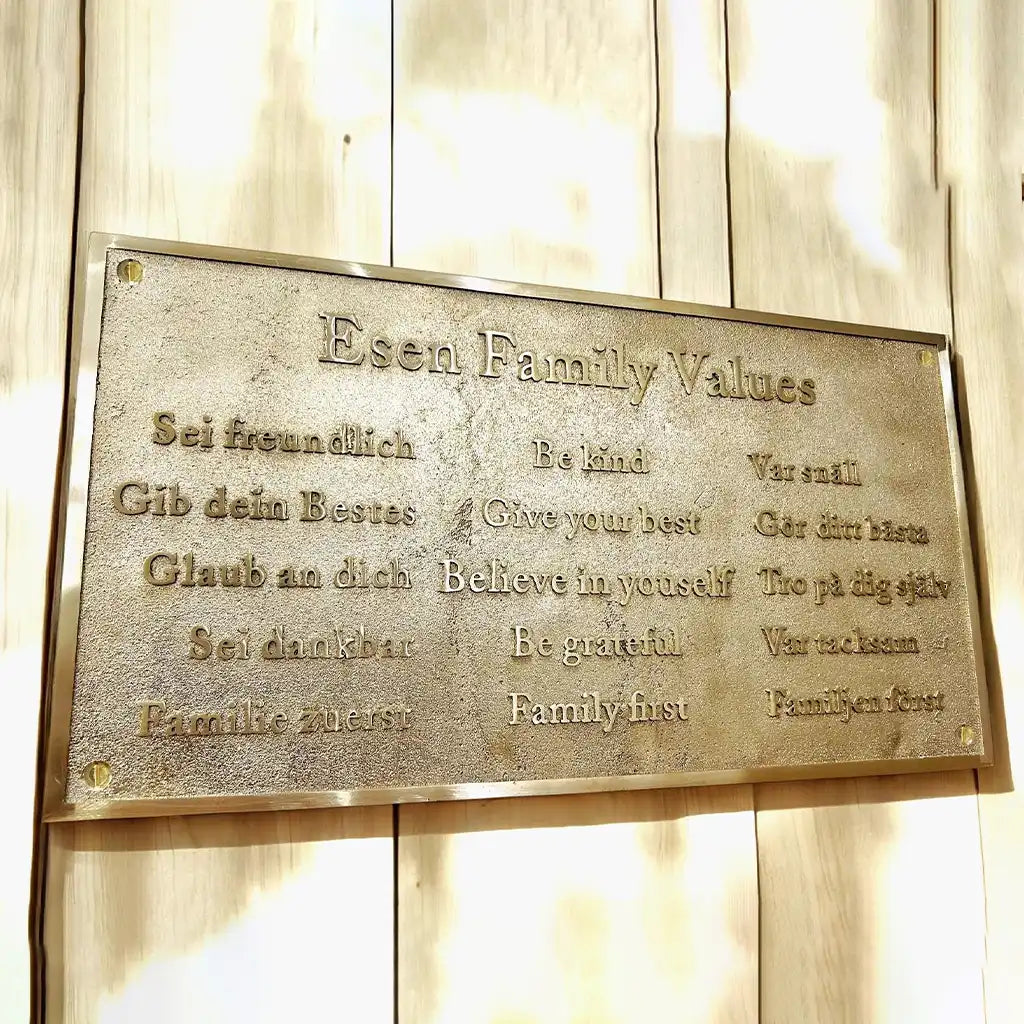 Brass plaque with 'Esen Family Values' on a wooden background | Custom engraved brass address plaque