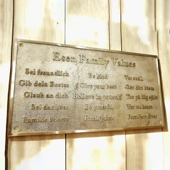 Brass plaque with 'Esen Family Values' on a wooden background | Custom engraved brass address plaque