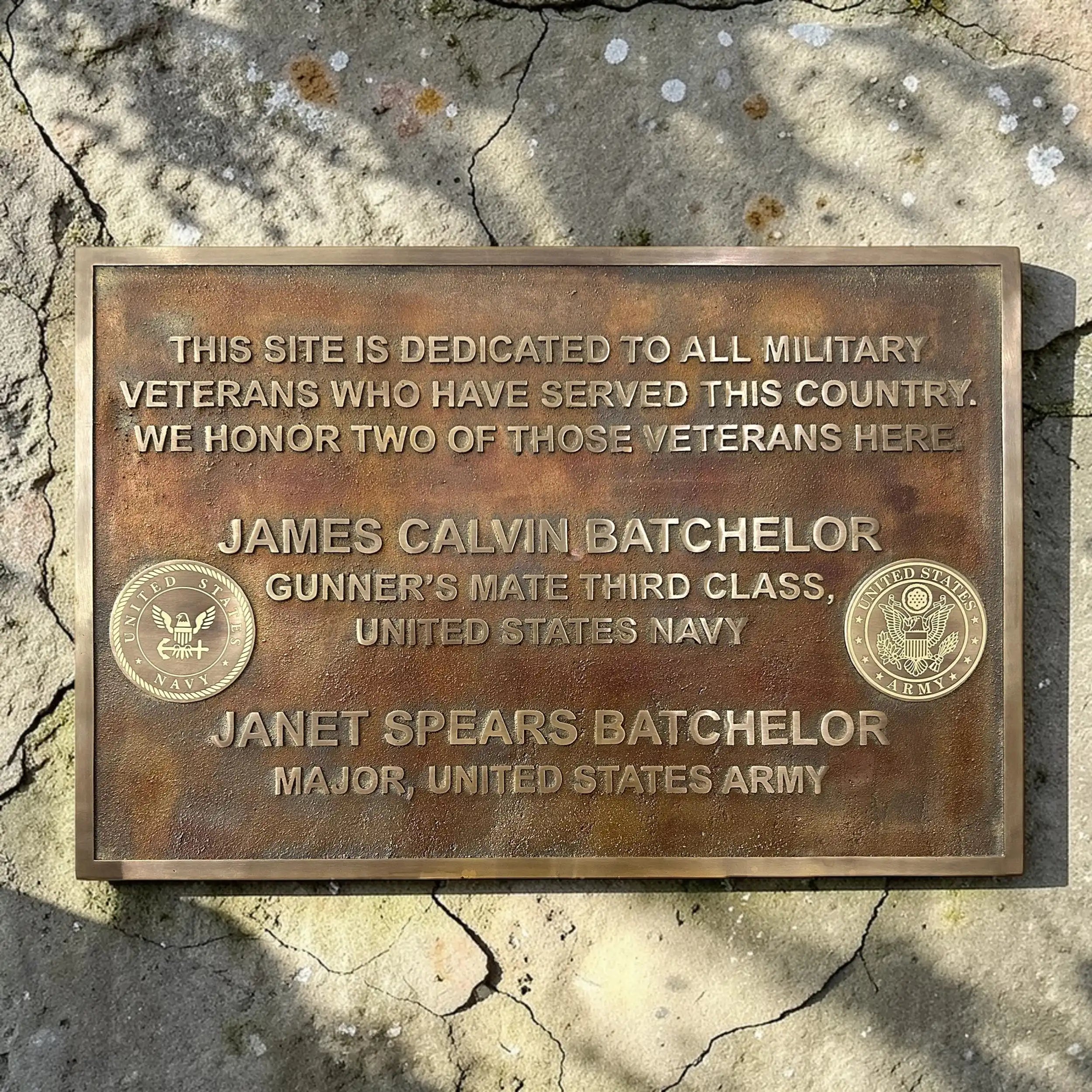 Bronze plaque dedicated to military veterans on a stone wall