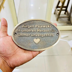 Bronze sign for house entrance
Oval bronze plaque outdoor