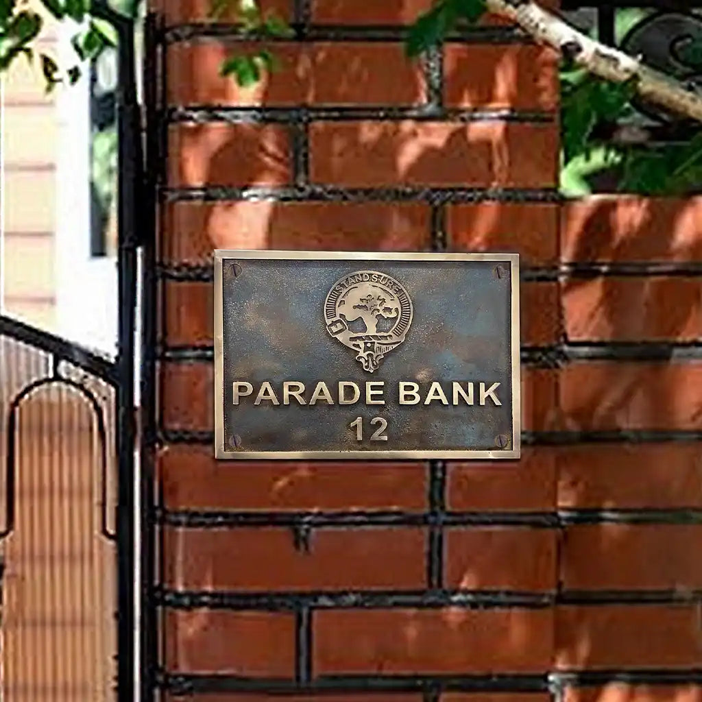 Decorative metal plaque with 'Parade Bank 12' on a brick wall background