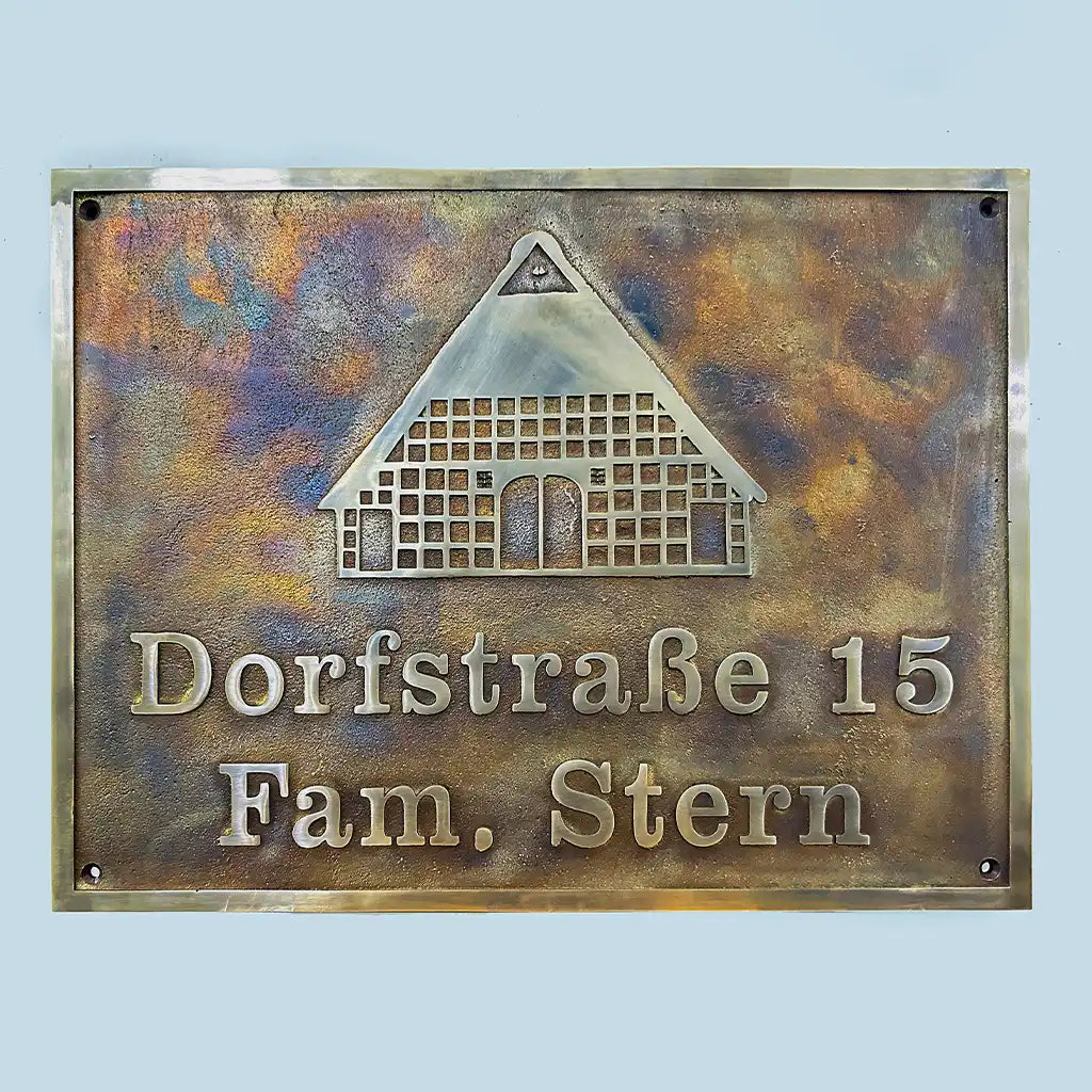 Personalized antique bronze sign, Bronze house plaque with text 'Dorfstraèe 15 Fam. Stern' on a light blue background