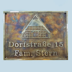 Personalized antique bronze sign, Bronze house plaque with text 'Dorfstraèe 15 Fam. Stern' on a light blue background