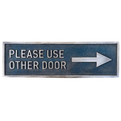 Bronze Metal Door Sign with 'Please Use Other Door' text and arrow on a white background
