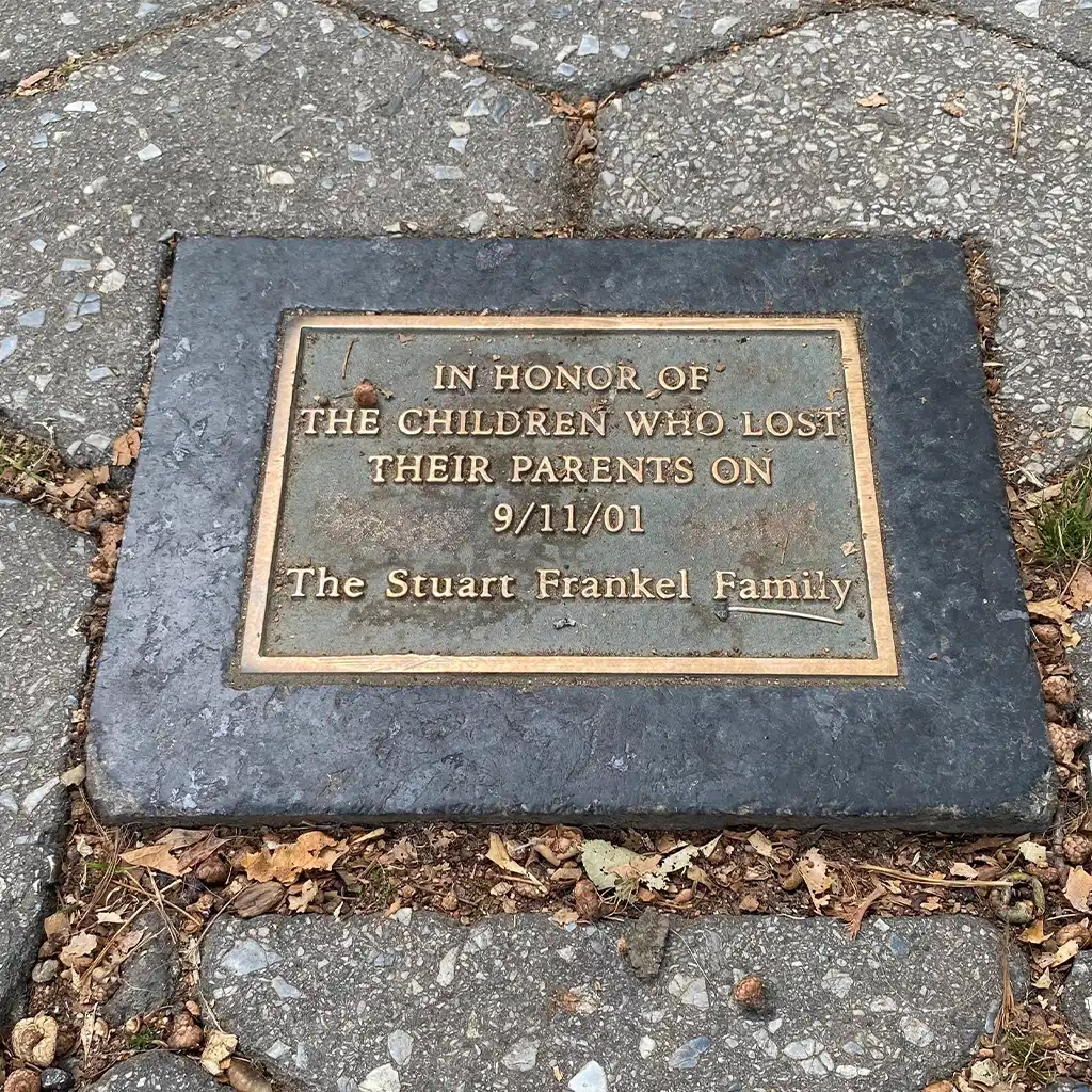 Bronze Memorial plaque dedicated to children lost on 9/11/01, placed on a stone pavement.