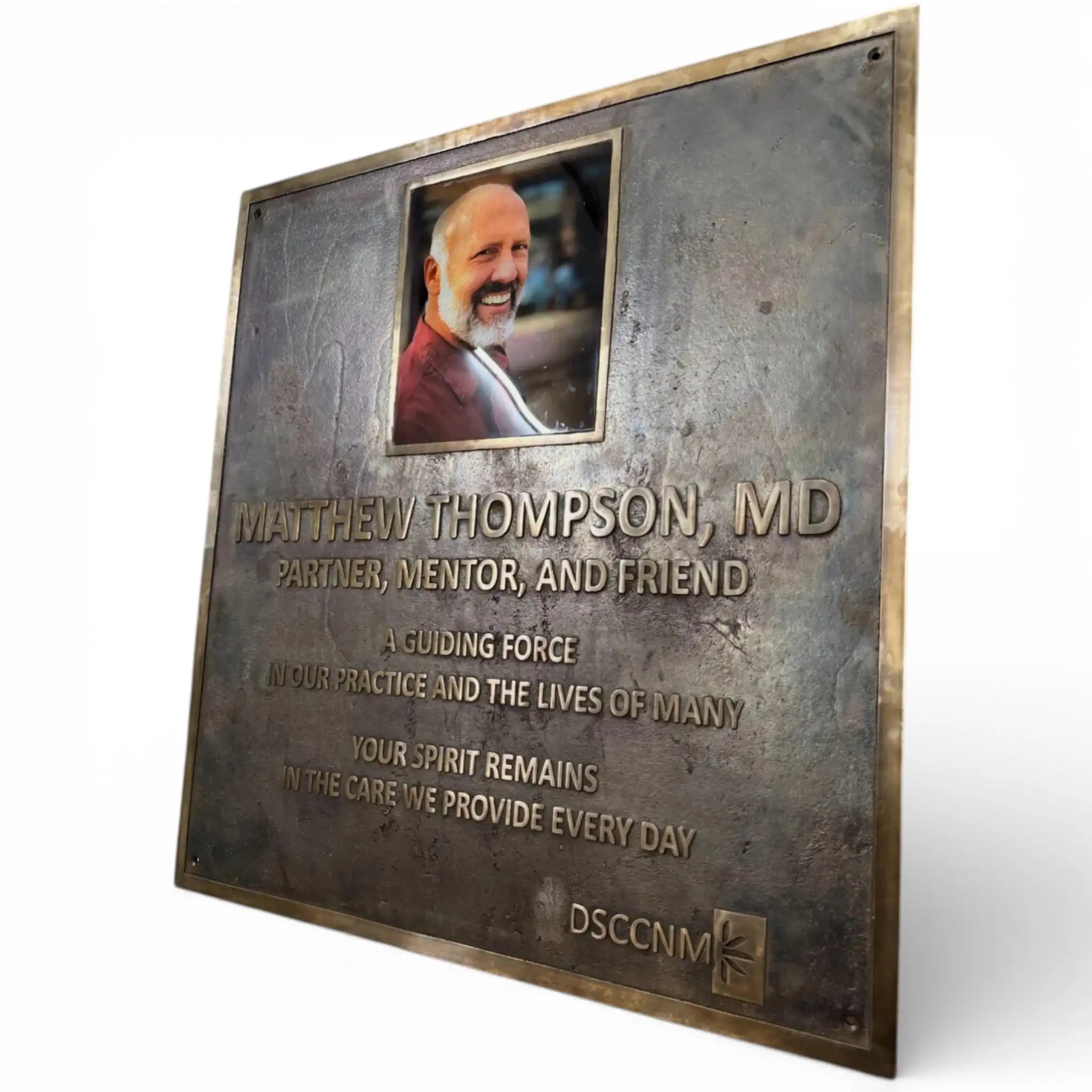 Plaque honoring Matthew Thompson, MD with a photo and text on a white background