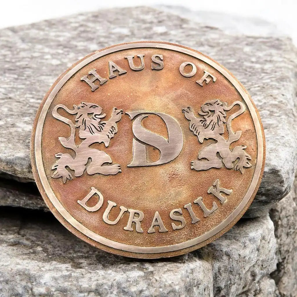 Bronze plaque for home entrance,
Custom bronze nameplate. Bronze coin with text and lion designs on a stone background