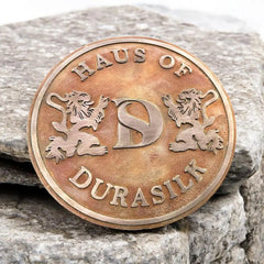 Bronze plaque for home entrance,
Custom bronze nameplate. Bronze coin with text and lion designs on a stone background