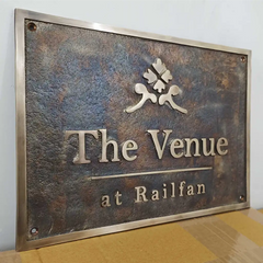 Outdoor bronze plaque antique style Metal sign with 'The Venue at Railfan' on a textured background