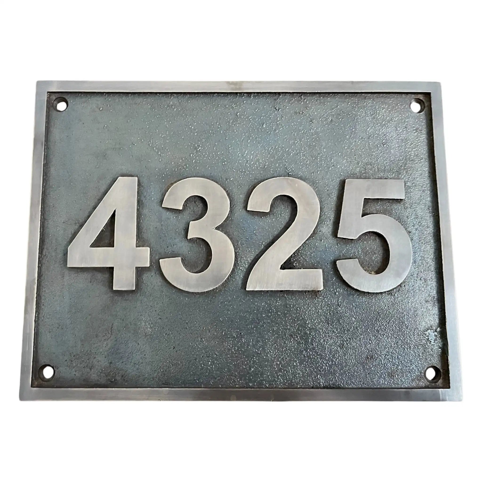 Bronze house number plate with the numbers 4325 on a white background