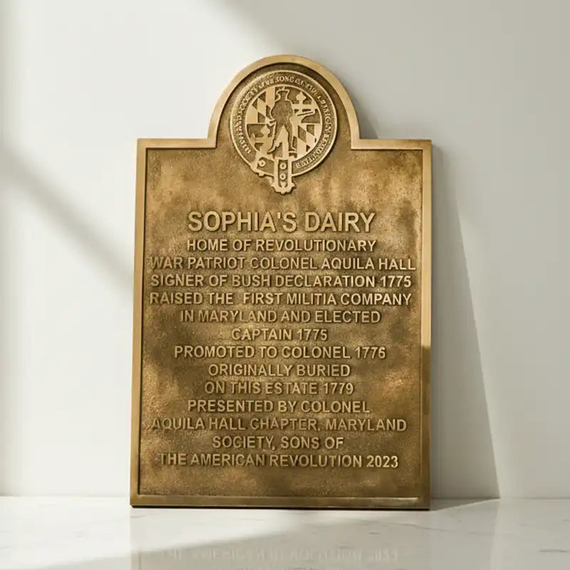 commemorative plaques with an arch-shaped bronze plaque with engraved text on a white background