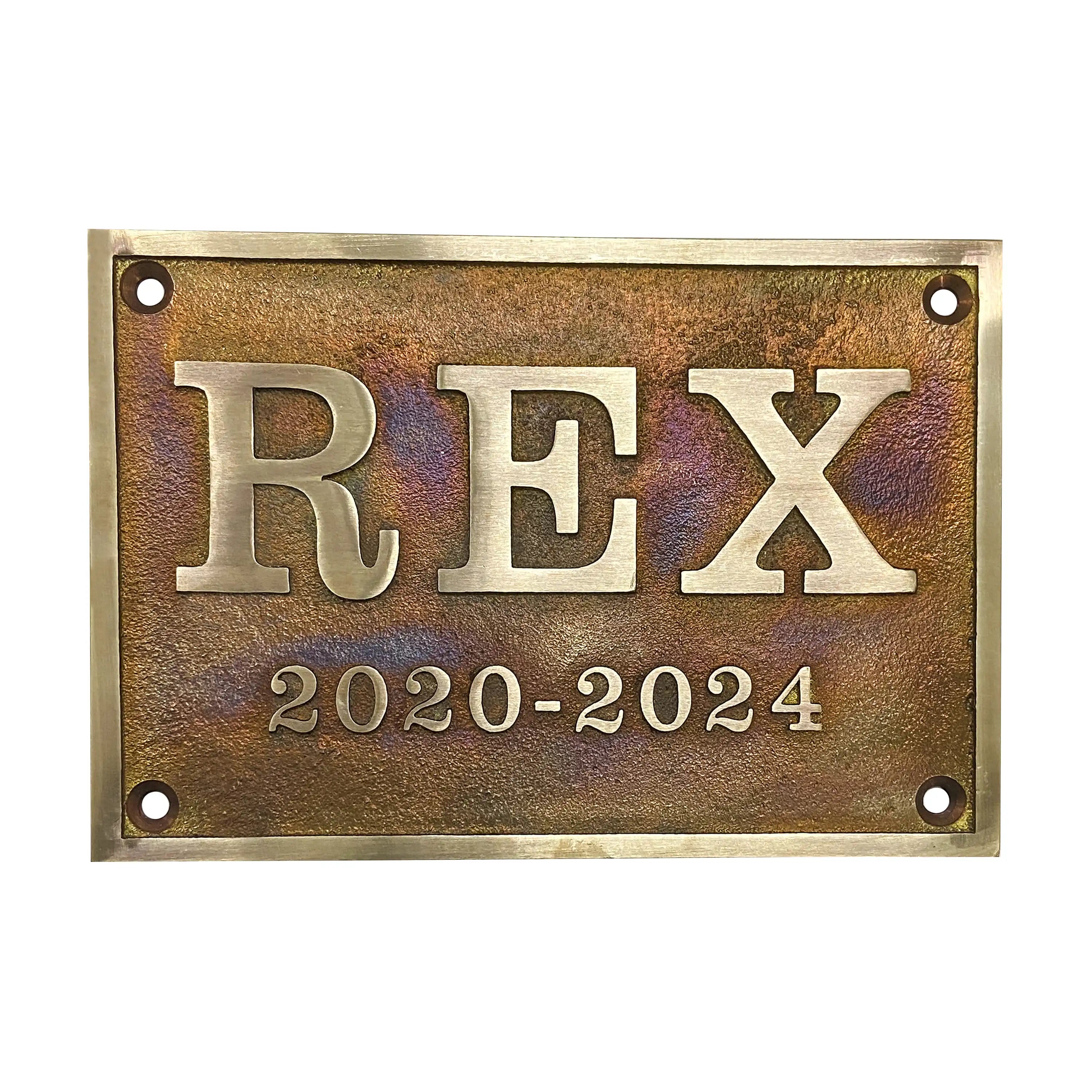 Brass plaque with 'REX' and dates 2020-2024 on a white background