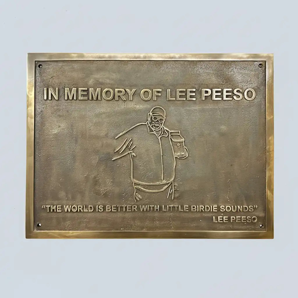 Bronze plaque with engraved text and illustration of custom text on a light gray background