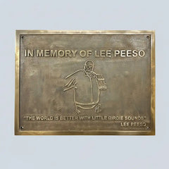 Bronze plaque with engraved text and illustration of custom text on a light gray background