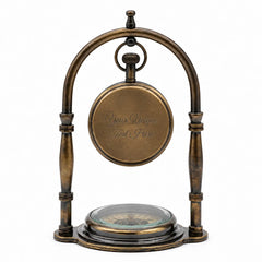 Back view of personalized antique brass desk clock with custom engraved message and compass base