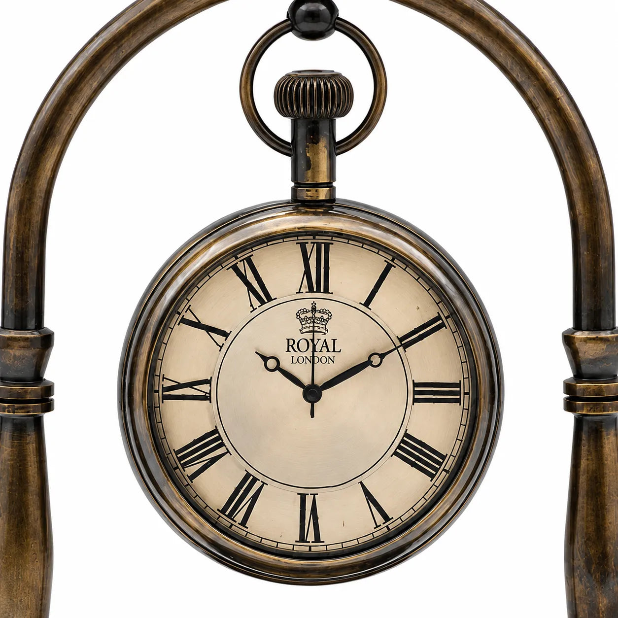 Close-up of antique brass desk clock face with Roman numerals and Royal London dial