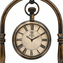 Close-up of antique brass desk clock face with Roman numerals and Royal London dial