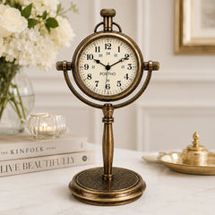 Antique brass desk clock on marble table