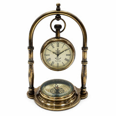 A vintage-style brass nautical clock and compass table decoration with a circular clock face, Roman numerals, and a compass rose on a glass cover, set against a plain white background.