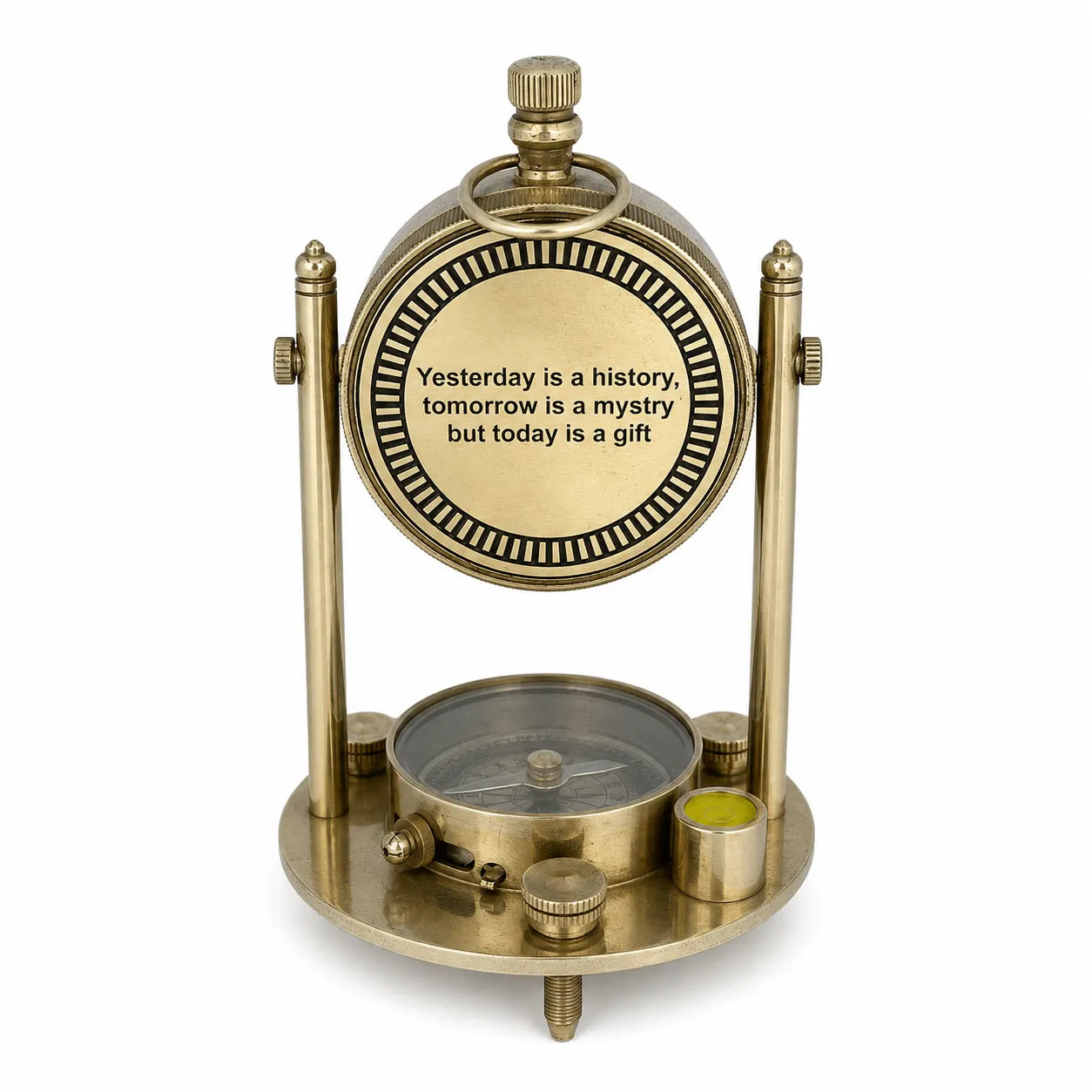 A vintage-style brass desk clock featuring a round dial that reads 'Yesterday is a history tomorrow is a mystery but today is a gift' and a small compass on the base, set against a plain white background.