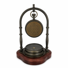 Rear view of brass desk clock with engraved clock back and compass base