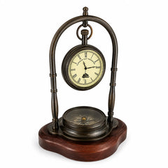 Three-quarter view of vintage brass desk clock with compass and wooden base